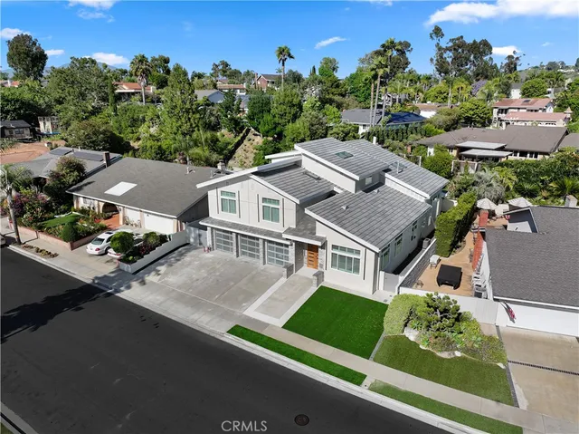 an aerial view of a residential houses with city view
