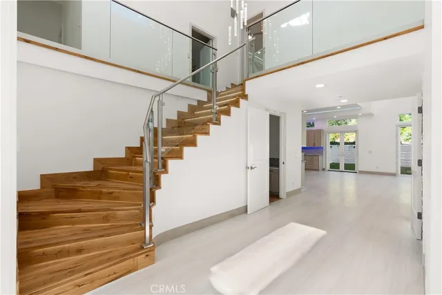 a view of front door and entryway with wooden floor