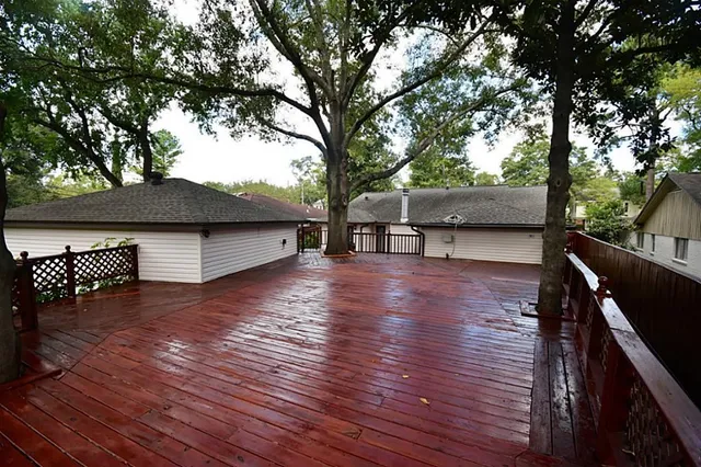 a view of outdoor space with wooden floor and trees