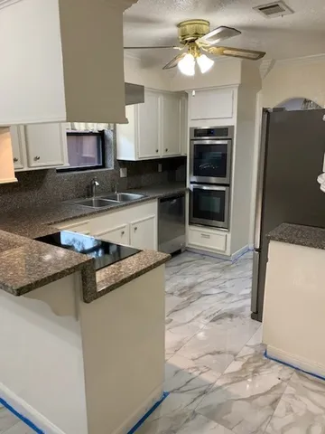 a kitchen with a refrigerator and a sink