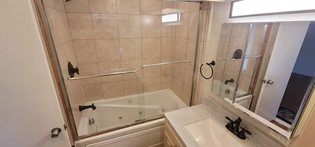 a bathroom with a tub and a shower