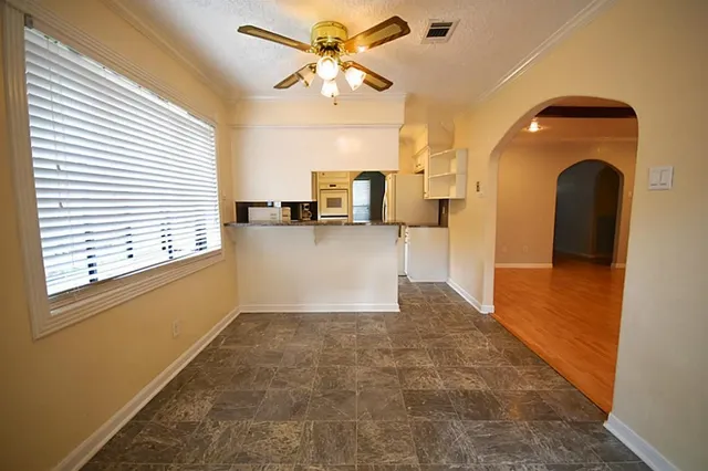 a view of a kitchen with a sink and cabinet with a fireplace