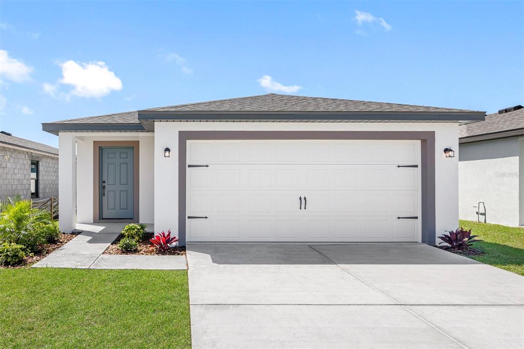 12456 Ruffed Grouse Road Weeki Wachee, FL 34614 - Photo 1 of 1 a front view of a house with a yard