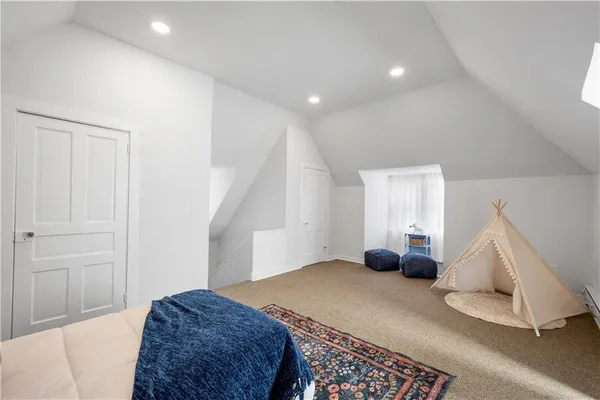 a room with a rug and a hallway