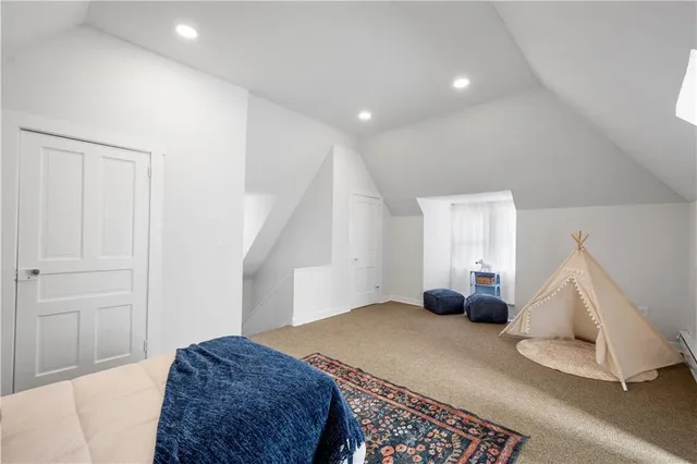 a room with a rug and a hallway