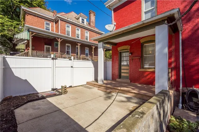 a backyard of a house with table and chairs