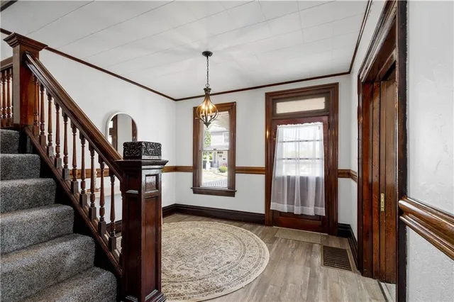 a view of an entryway with wooden floor and livingroom view