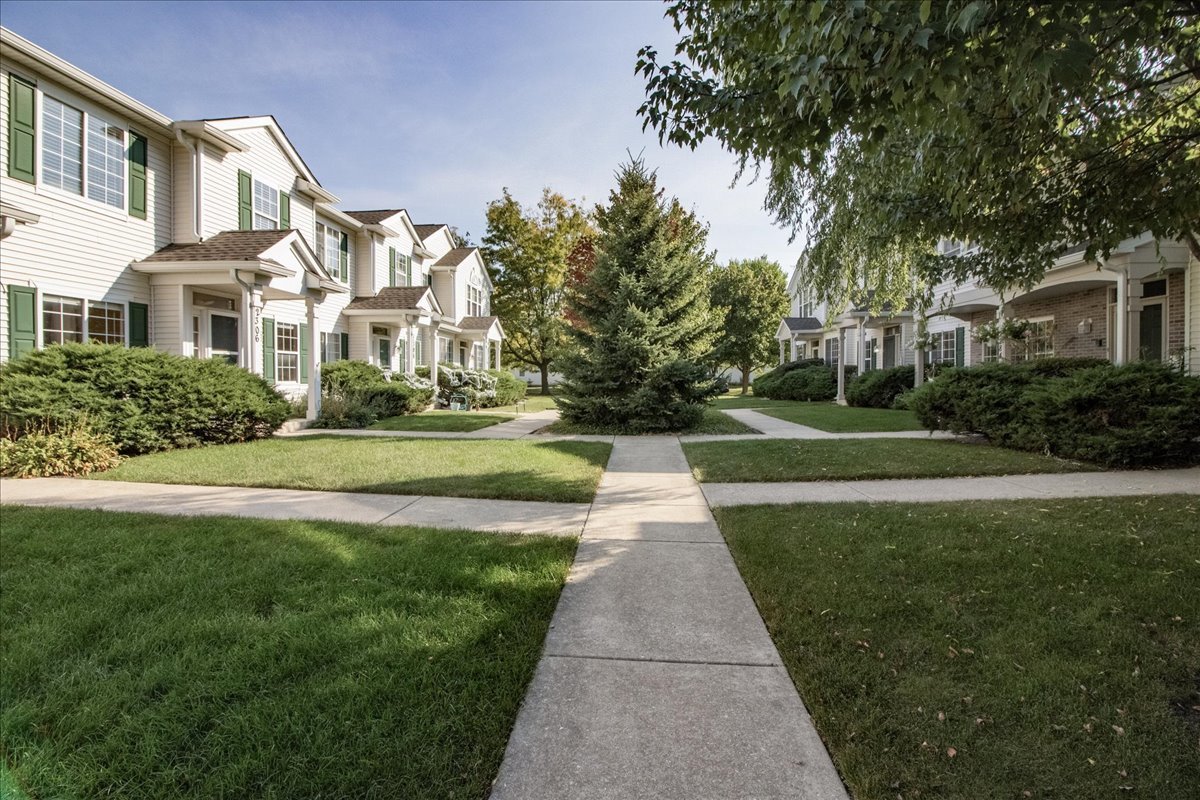 2306 Reflections Drive Aurora, IL 60502 - Photo 5 of 6 a front view of a building with garden