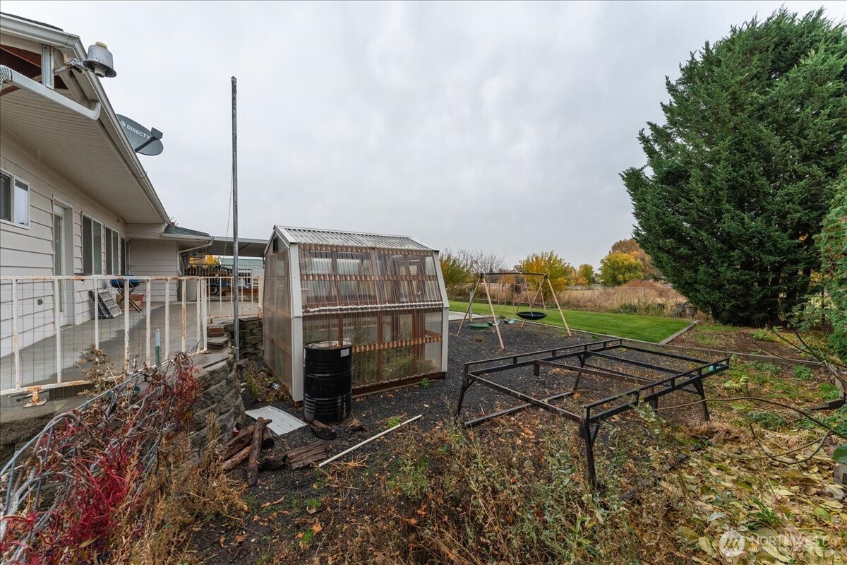 20271 Linden Road Northwest Soap Lake, WA 98851 - Photo 6 of 22 a chairs and bench sitting in front of a house