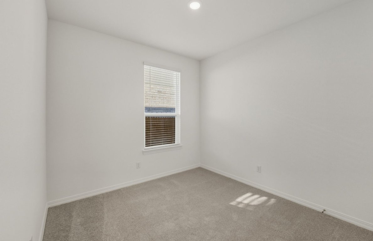472 Tailwind Drive Kyle, TX 78640 - Photo 17 of 22 a view of an empty room with a window