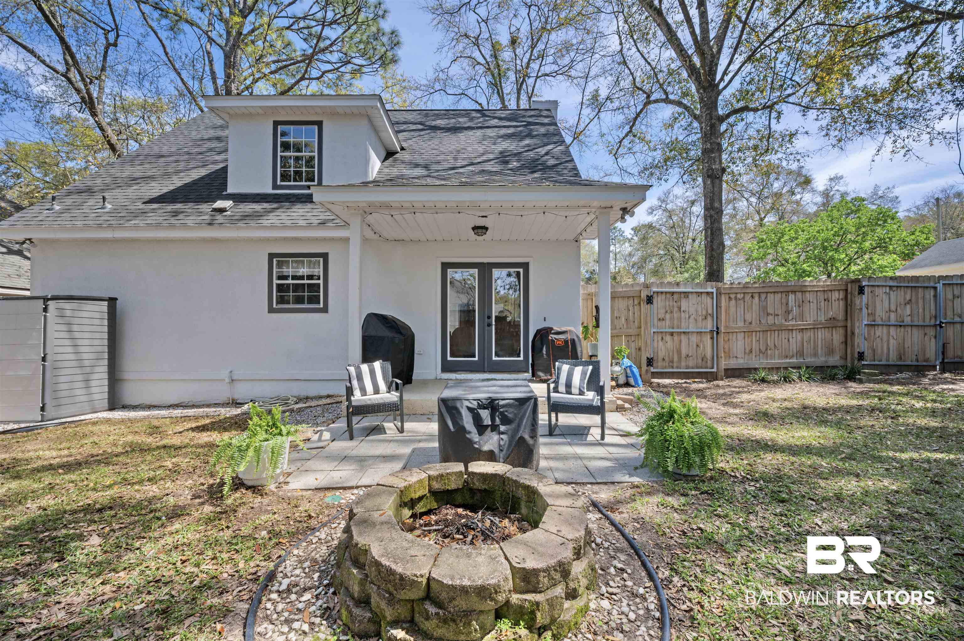 1066 Linlen Avenue Mobile, AL 36609 - Photo 20 of 22 Rear view of property featuring stucco siding, fence, a patio, french doors, and a shingled roof