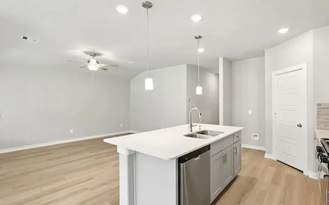 a bathroom with a sink a light fixture and a mirror