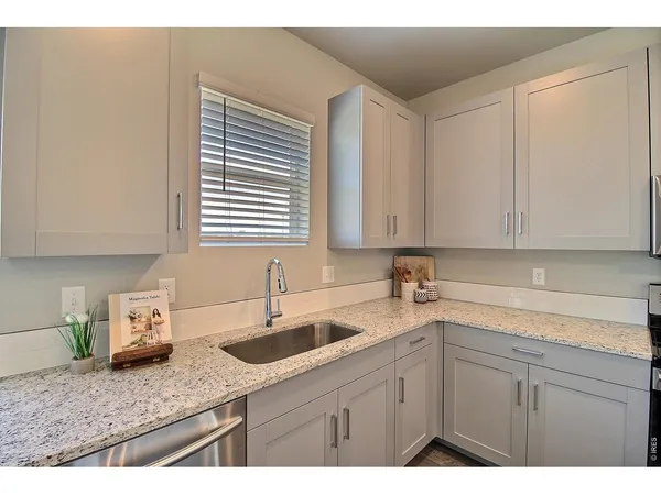 a kitchen with sink and cabinets
