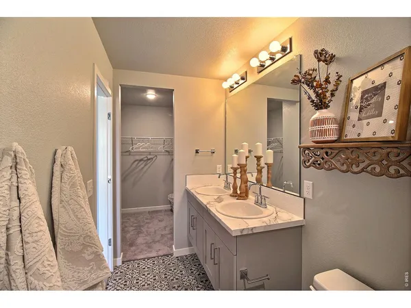 a bathroom with a sink a mirror and a shower