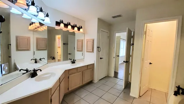 a large bathroom with a sink mirror and a shower