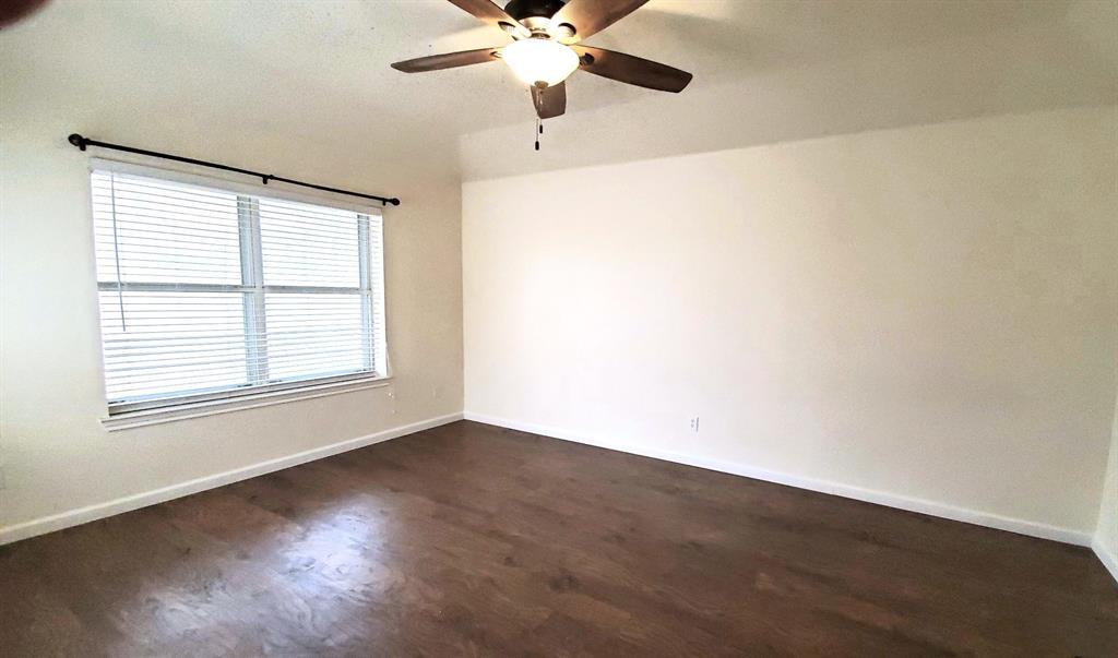 8017 Clipper Street Frisco, TX 75035 - Photo 16 of 21 a view of an empty room with wooden floor and a window