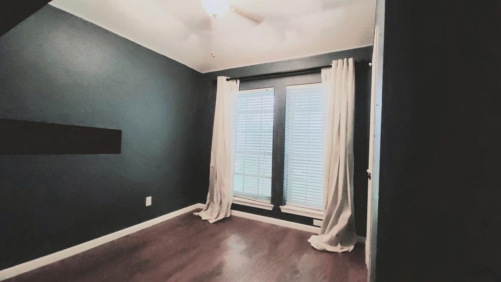 8017 Clipper Street Frisco, TX 75035 - Photo 19 of 21 an empty room with wooden floor and windows