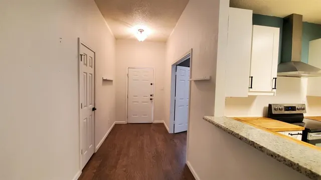 a view of a kitchen with a sink and wooden floor