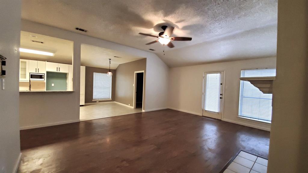 8017 Clipper Street Frisco, TX 75035 - Photo 5 of 21 a view of an empty room with window and wooden floor