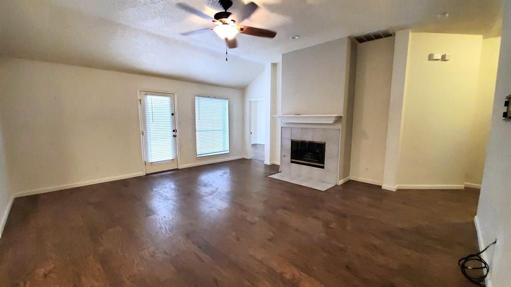 8017 Clipper Street Frisco, TX 75035 - Photo 6 of 21 a view of a livingroom with wooden floor and a ceiling fan
