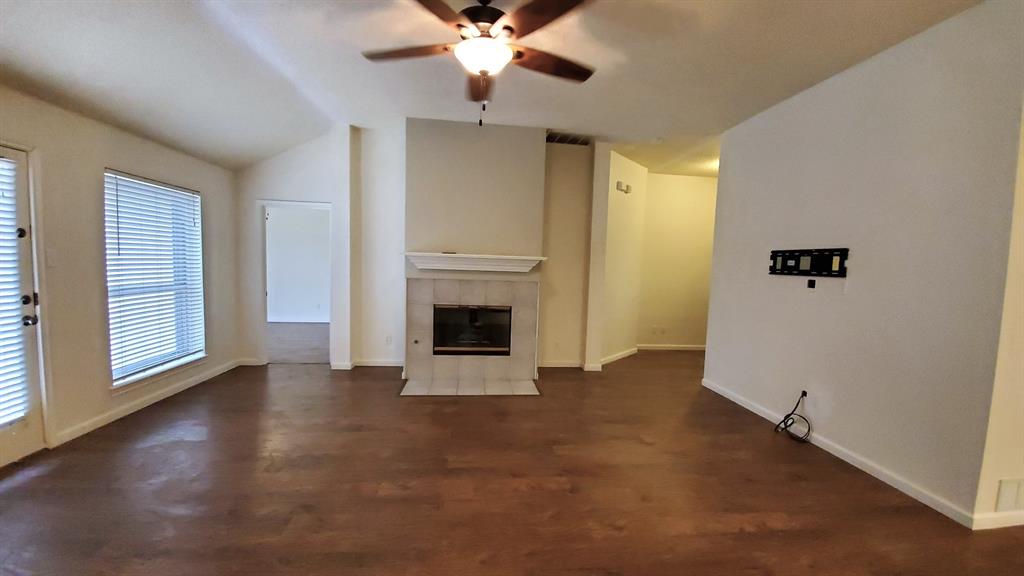 8017 Clipper Street Frisco, TX 75035 - Photo 7 of 21 an empty room with windows and a fireplace