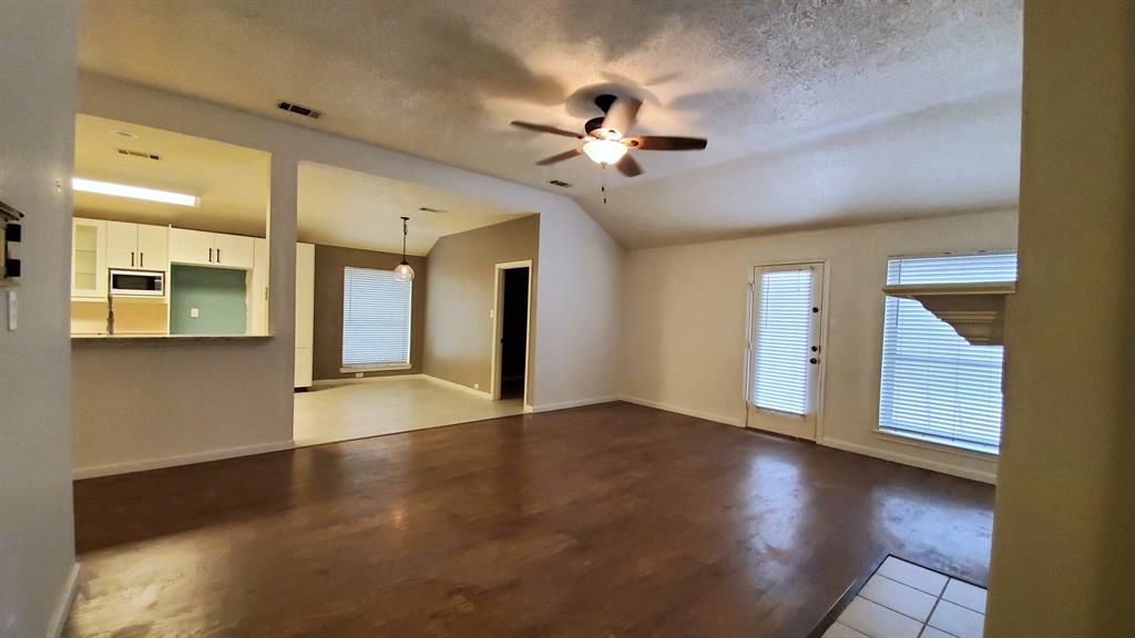 8017 Clipper Street Frisco, TX 75035 - Photo 8 of 21 a view of an empty room with window and wooden floor