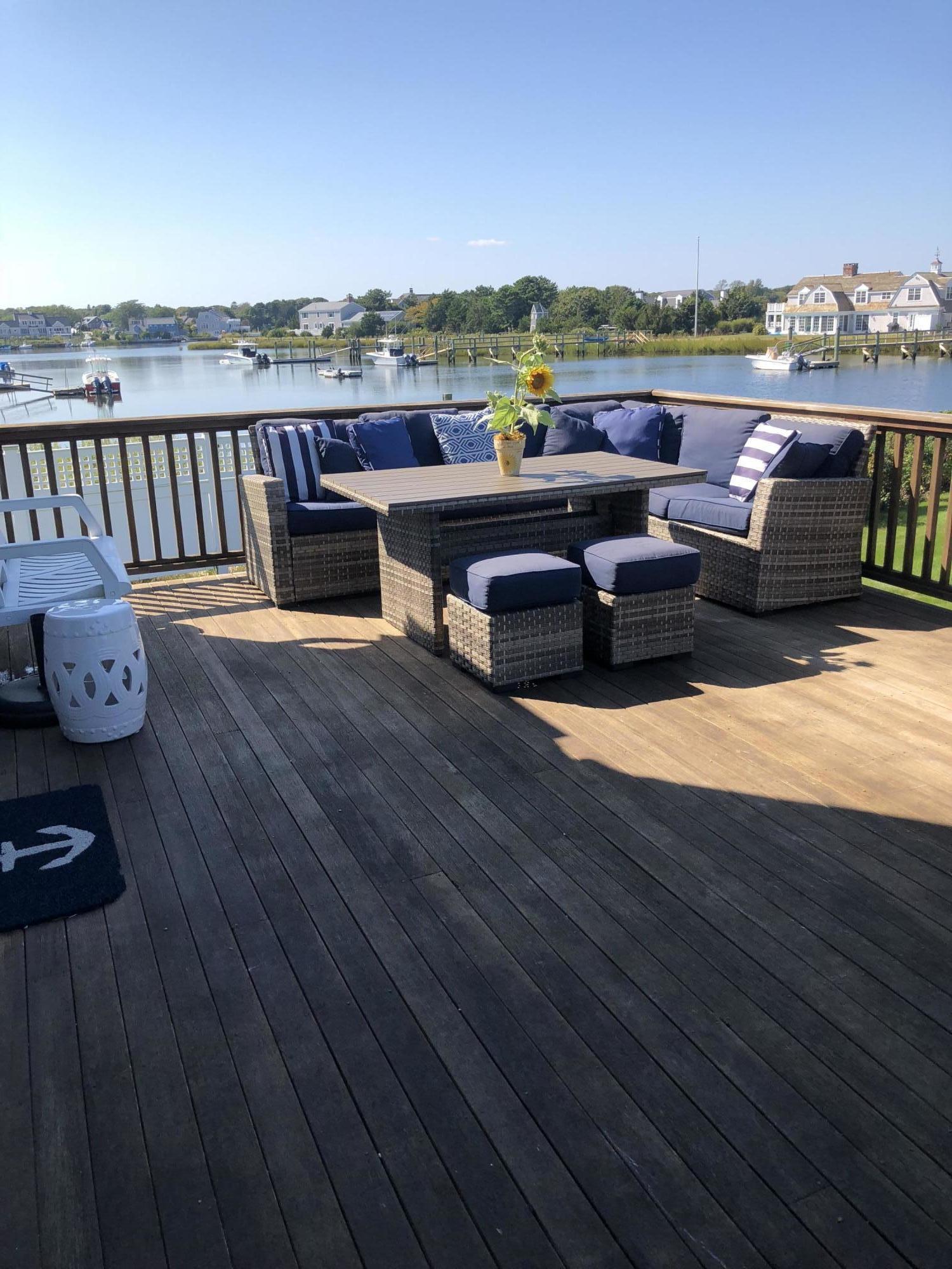 62 Long Beach Road Centerville, MA 02632 - Photo 4 of 27 a view of a terrace with furniture and city view