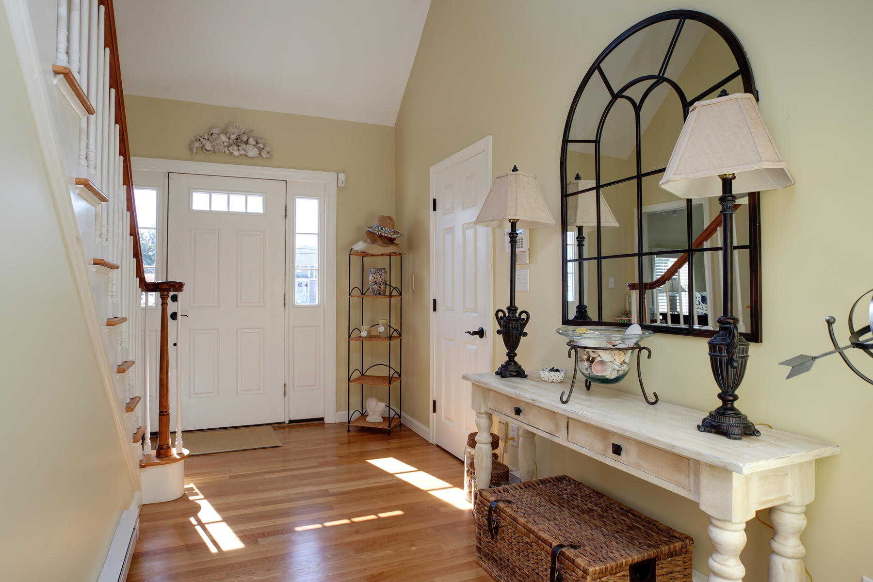 62 Long Beach Road Centerville, MA 02632 - Photo 5 of 27 a view of an entryway with wooden floor and mirror