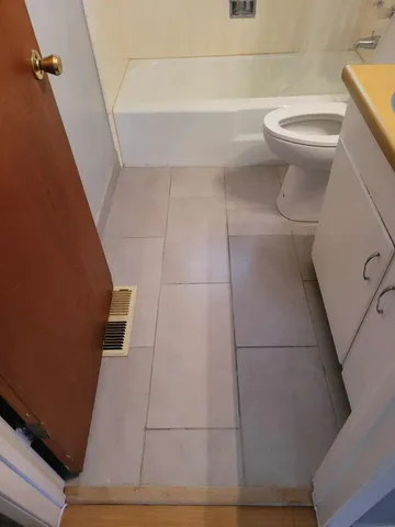 a bathroom with a toilet and a shower