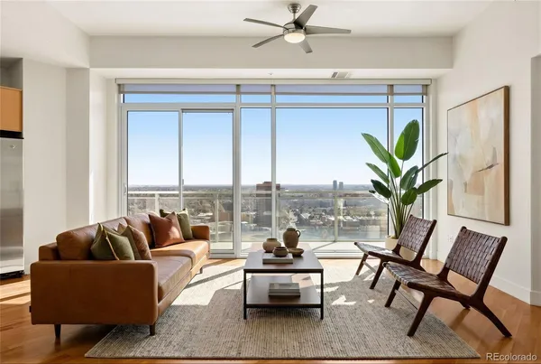 a living room with furniture and a potted plant