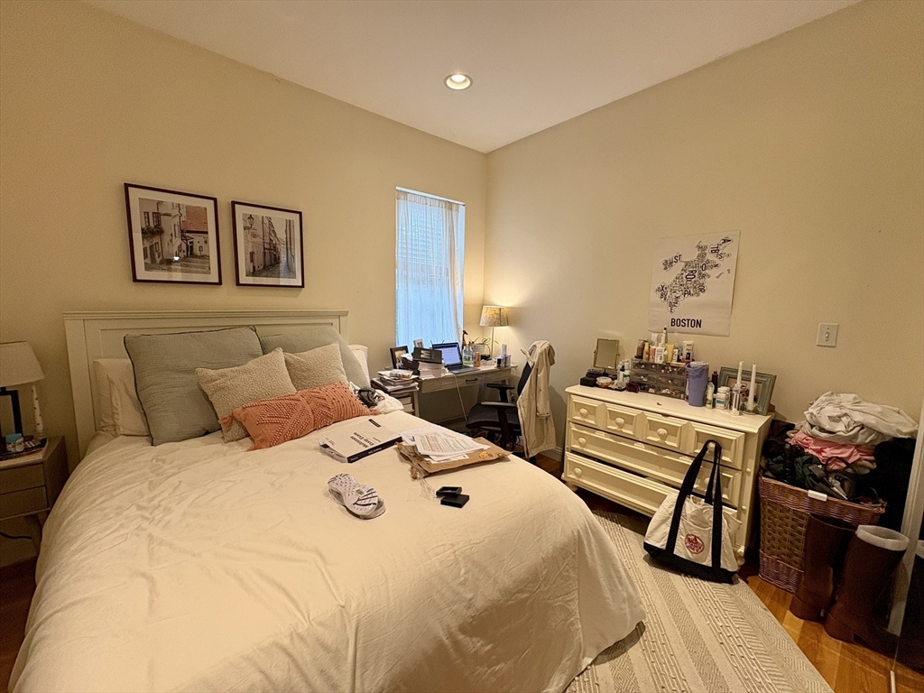 1801 Beacon Street, Unit 4 Brookline, MA 02445 - Photo 2 of 9 a bedroom with a bed and wooden floor
