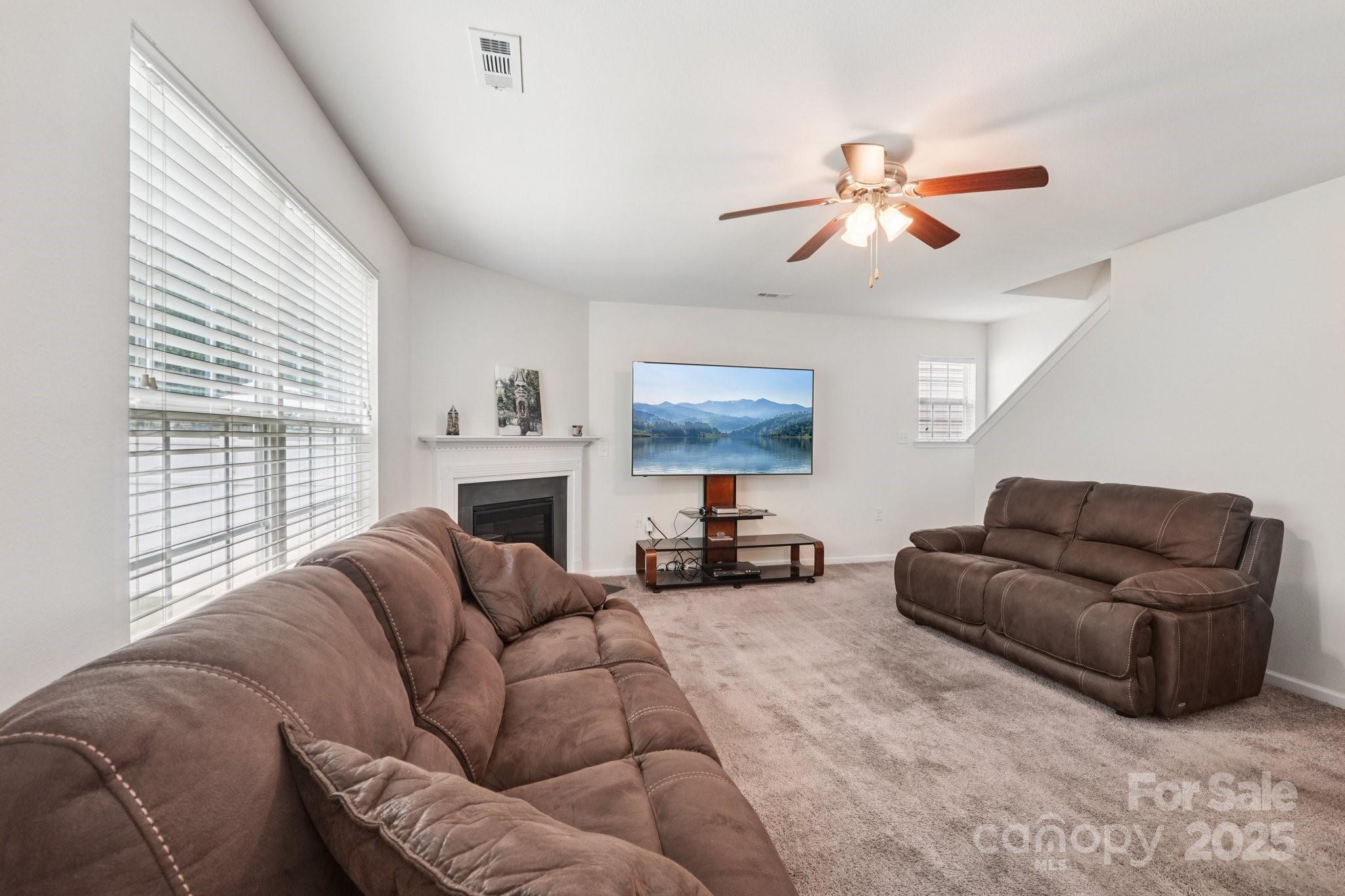 2289 Reid Pointe Avenue Indian Land, SC 29707 - Photo 16 of 39 a living room with furniture a fireplace and a large window