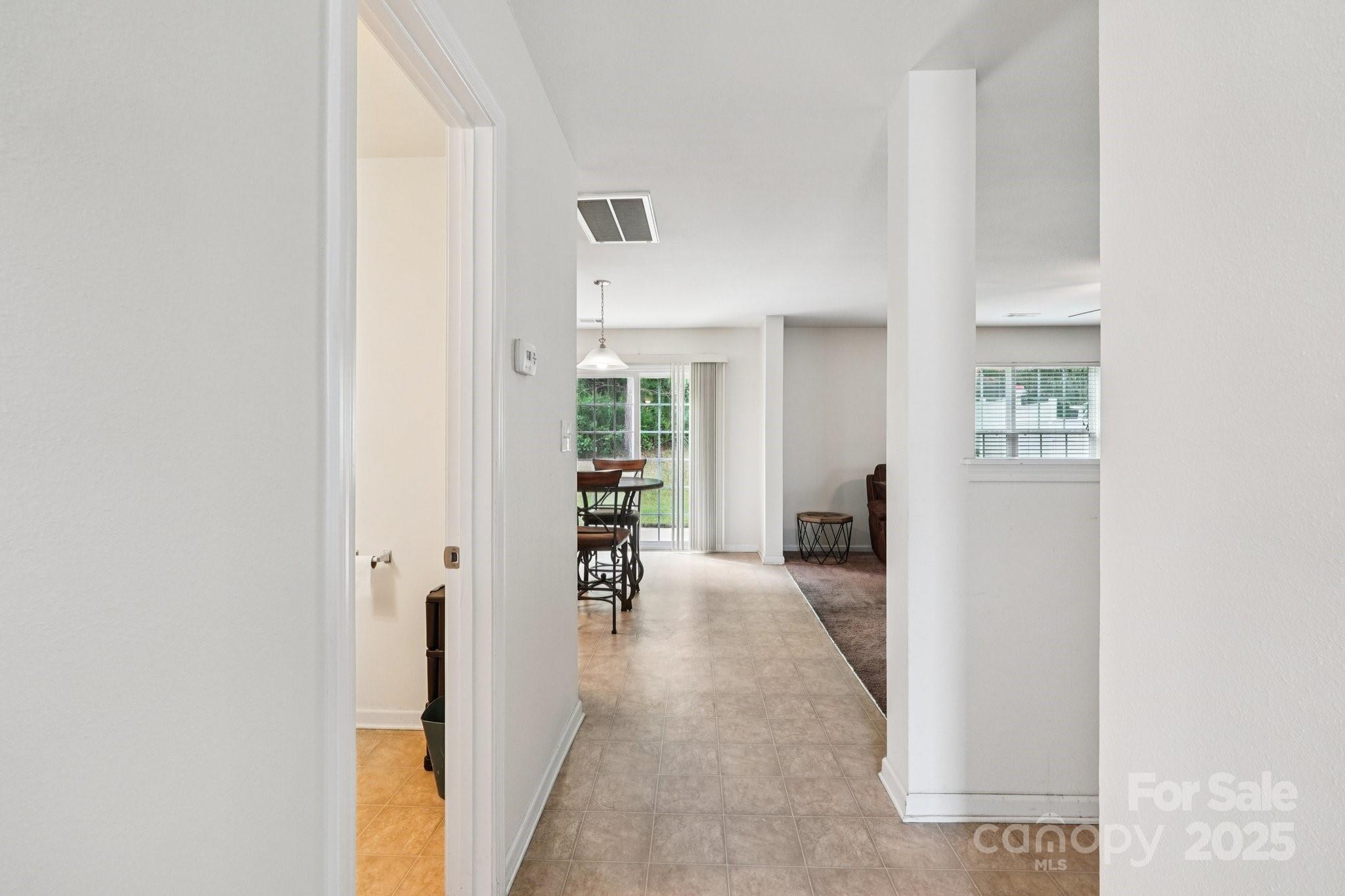 2289 Reid Pointe Avenue Indian Land, SC 29707 - Photo 6 of 39 a view of a hallway with wooden floor and a living room