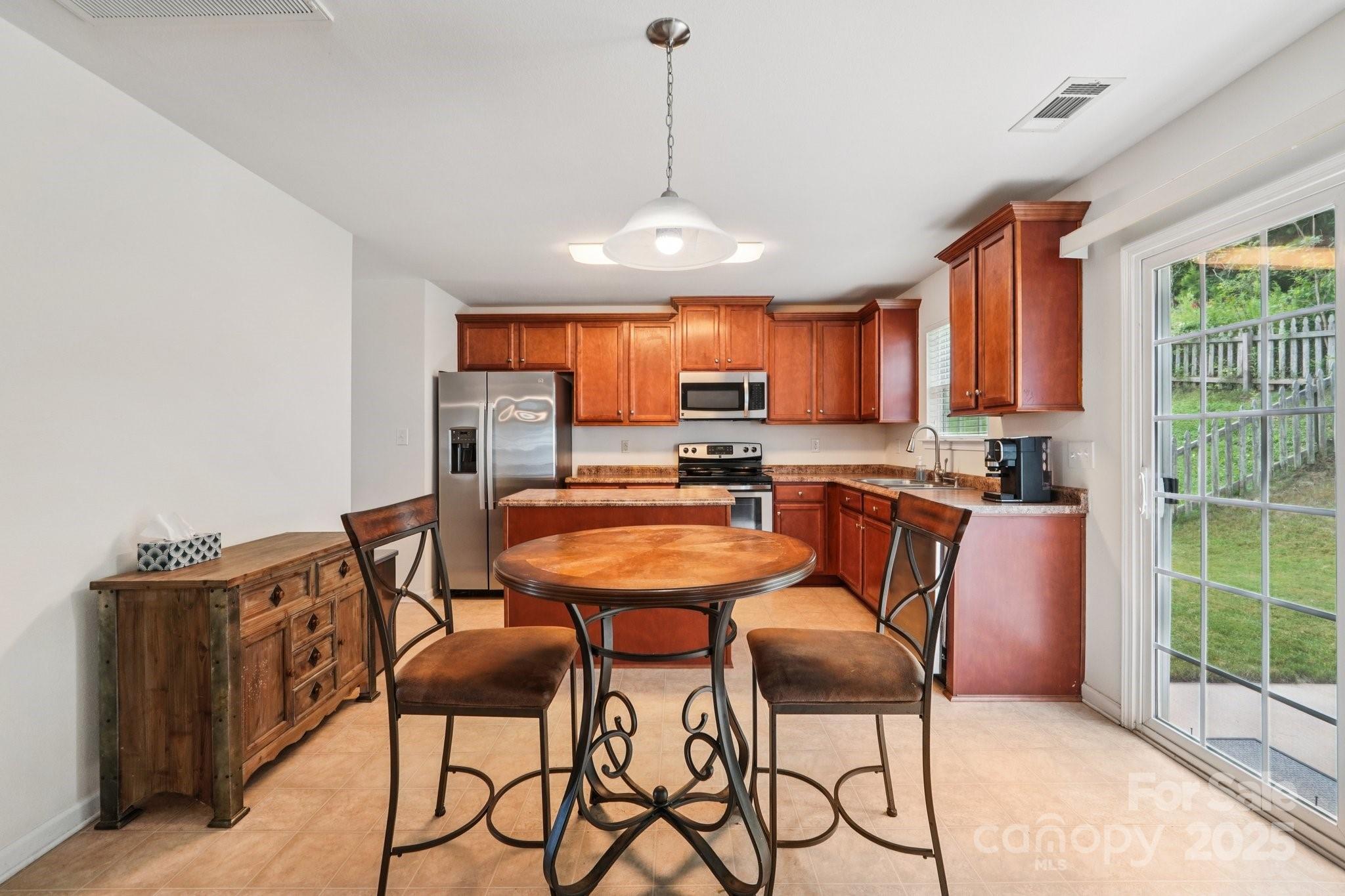 2289 Reid Pointe Avenue Indian Land, SC 29707 - Photo 8 of 39 a dining room filled chandelier and wooden furniture