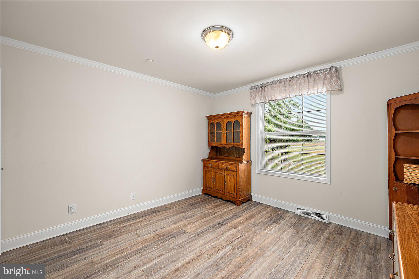 8225 Whitesville Road Pittsville, MD 21850 - Photo 17 of 45 an empty room with wooden floor and windows