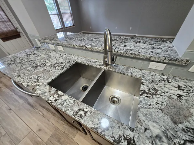 a utility room with wooden floor washer and dryer