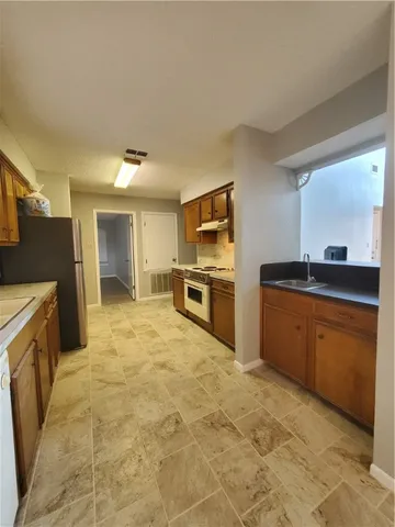 a large kitchen with cabinets and stainless steel appliances