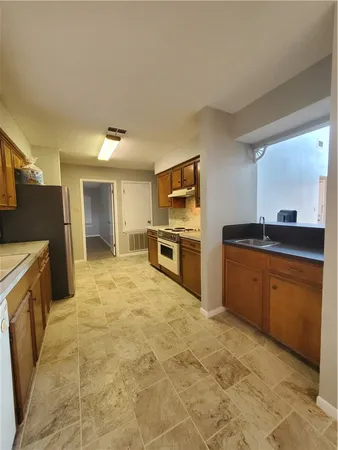 a large kitchen with cabinets and stainless steel appliances