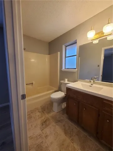 a bathroom with a double vanity sink toilet mirror and shower