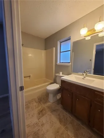 a bathroom with a double vanity sink toilet mirror and shower