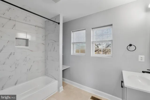 a bathroom with a bathtub and shower