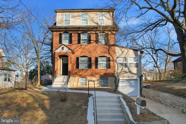 a view of a brick house with large windows