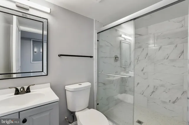 a bathroom with a sink mirror toilet and shower