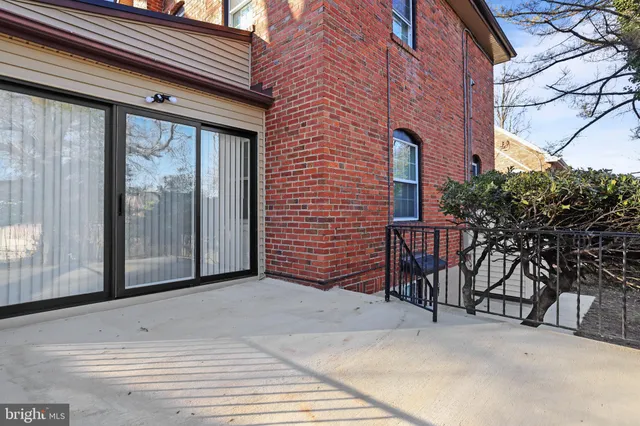 a view of a patio with table and chairs and potted plants