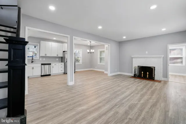 a view of a kitchen with a sink and a fireplace