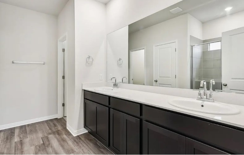 163 Pendleton Drive Kyle, TX 78640 - Photo 13 of 15 a bathroom with a double vanity sink and mirror