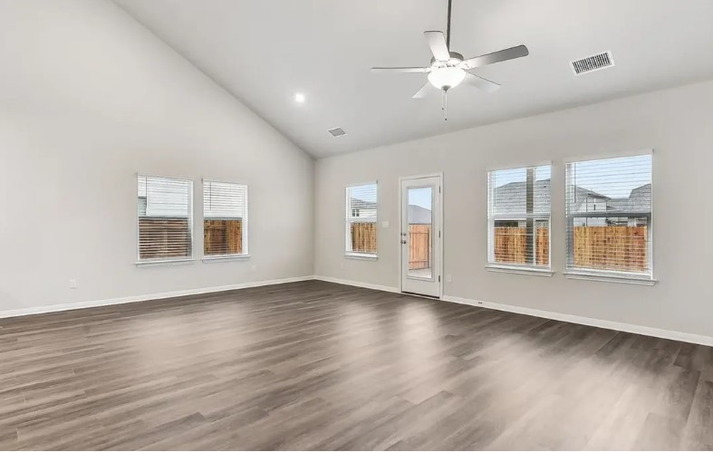 163 Pendleton Drive Kyle, TX 78640 - Photo 10 of 15 a view of an empty room with window and wooden floor