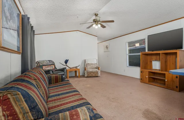 a bedroom with furniture and a flat screen tv
