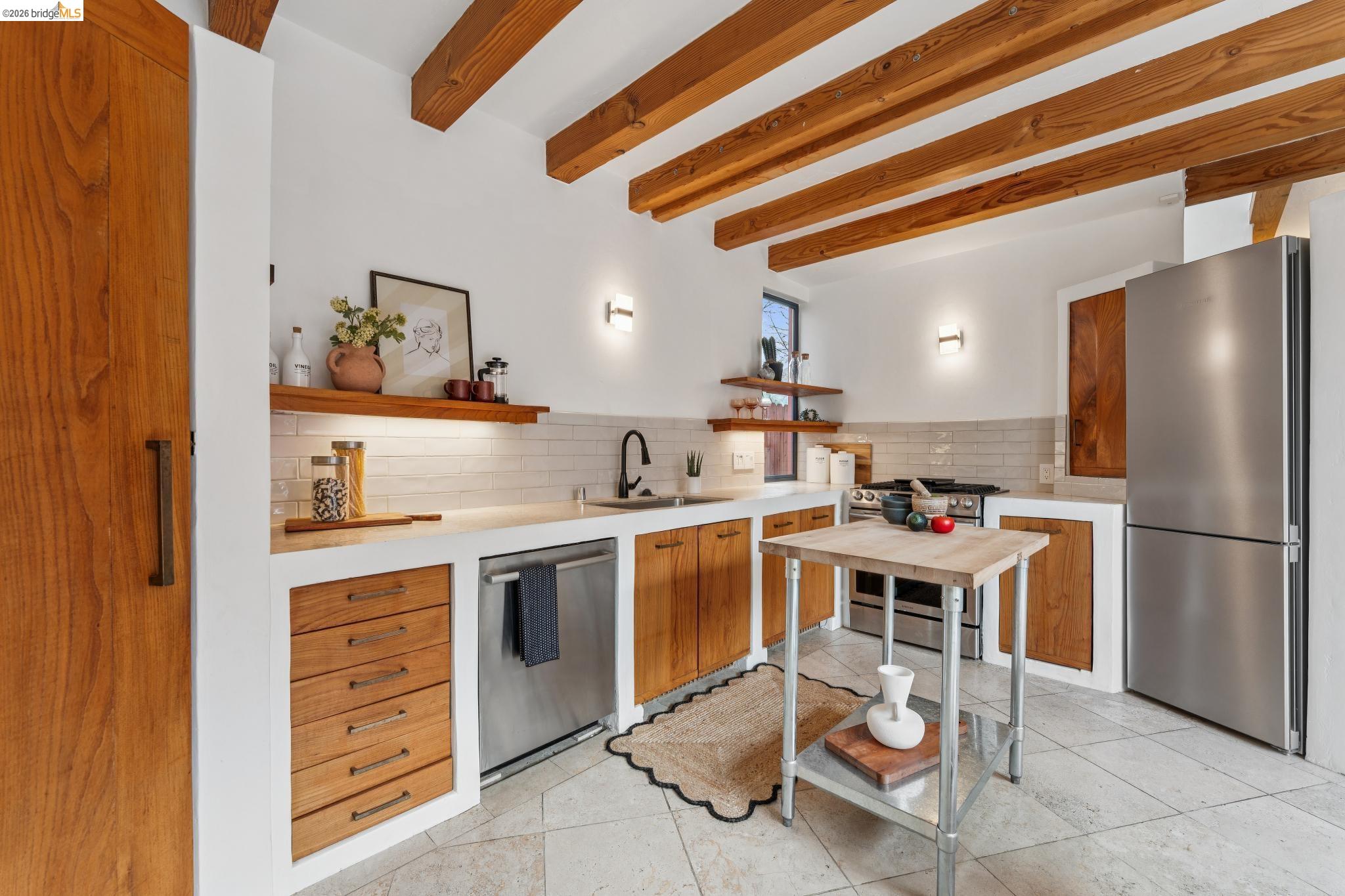 2015 Delaware Street, Unit A Berkeley, CA 94709 - Photo 14 of 60 a kitchen with a sink a refrigerator and wooden cabinets