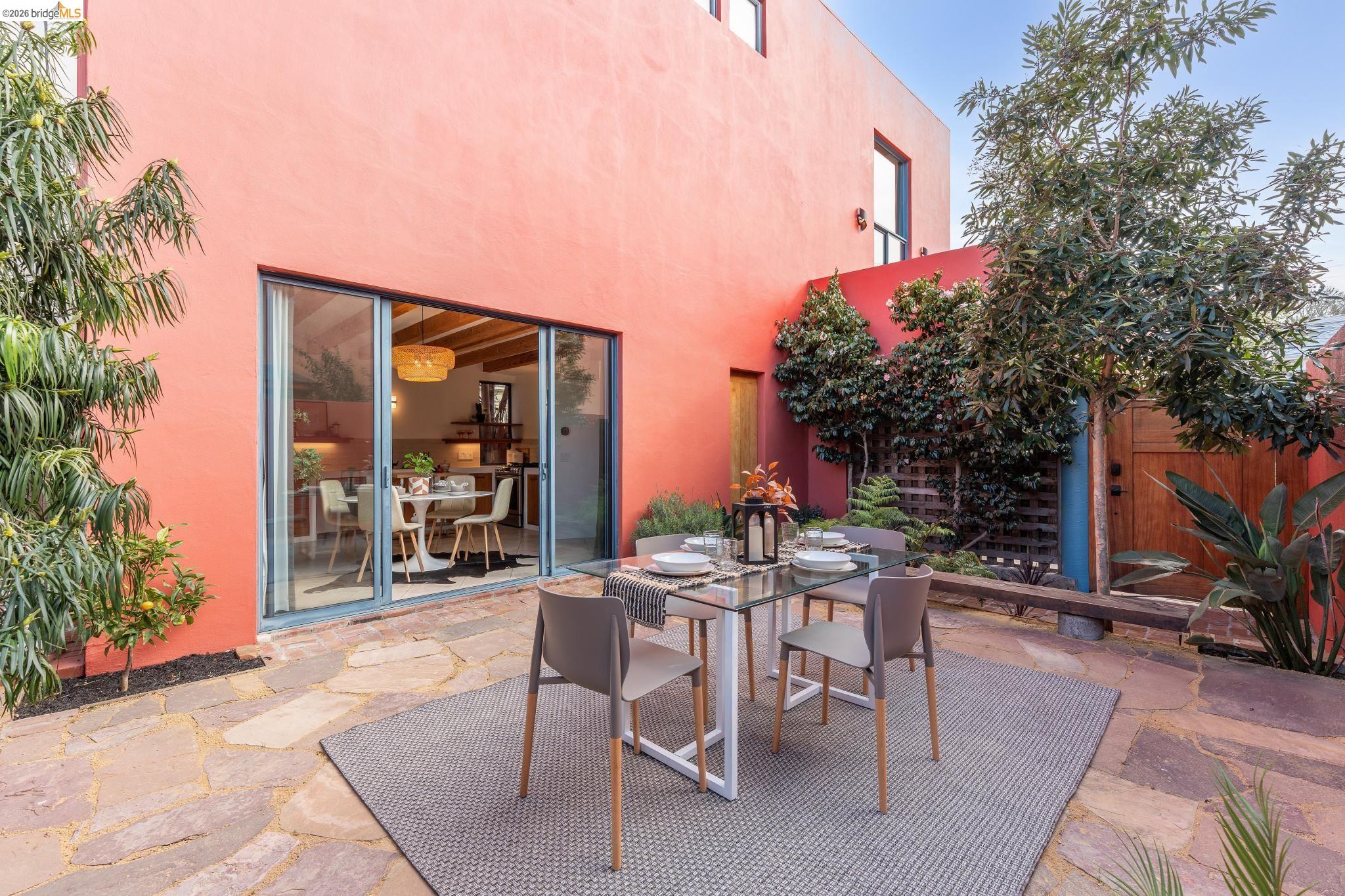 2015 Delaware Street, Unit A Berkeley, CA 94709 - Photo 20 of 60 a view of a patio with a table and chairs and potted plants